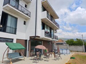 a building with chairs and tables in front of it at Hotel Manglisi Hills in Manglisi