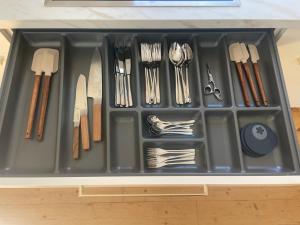 a tray filled with utensils in a drawer at Historic Charm Apartment Bayreuth in Bayreuth