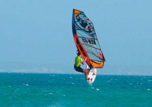 a man windsurfing in the ocean on the water at Yaque Breeze - Beach Apartament in El Yaque