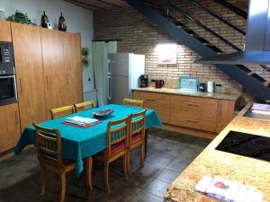 a kitchen with a table with chairs and a refrigerator at Era Cal Anton in Alás