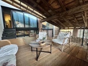 a living room with a table and chairs on a balcony at Era Cal Anton in Alás
