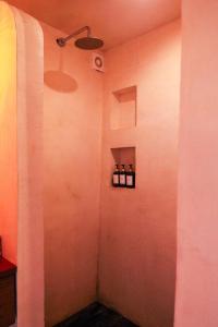 a room with three bottles of wine on a wall at GlampCalar lagoon Front Bungalows in Rancho Bacalar +31 photos