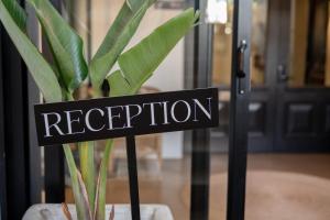 Ein Schild mit der Aufschrift „Rezeption“ vor einem Werk in der Unterkunft Eleven in Plettenberg Bay + 253 Fotos