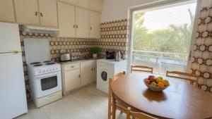 a kitchen with a table with a bowl of fruit on it at Kineta Prime Suites No2 in Kineta