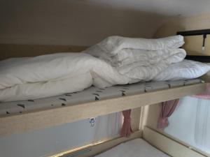 a stack of pillows on a bunk bed at Stetind Skicamp in Lyngen