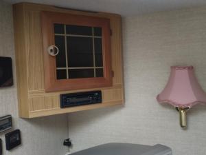a cabinet with a window and a pink lamp at Stetind Skicamp in Lyngen +54 photos