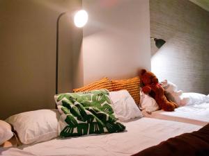 two teddy bears sitting on top of a bed at Toyo Yoyoginumi in Tokyo