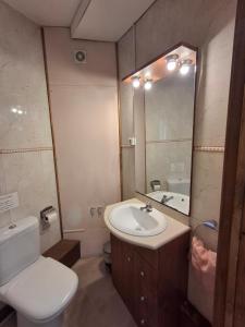 a bathroom with a sink and a toilet and a mirror at Setcases-Vallter Hostal Mitja Pensió 5 in Setcases