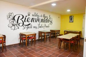 a restaurant with tables and chairs and a sign on the wall at Hotel 7 De Septiembre in San Clemente del Tuyú
