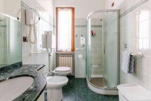 a bathroom with a toilet and a sink and a shower at Apartment Superiore a 950 metri dal mare in Albisola Superiore +27 photos