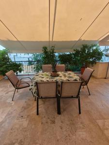 a table and chairs in a room with a table at Vivari apartment in Vivari