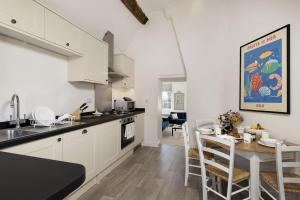 a kitchen and dining room with a table and chairs at The Haven in Chipping Norton