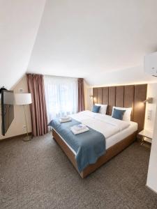 a bedroom with a large bed and a television at Oysters & Bubbles Gastro Rooms Rynek Square in Poznań