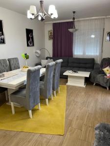 a dining room and living room with a table and chairs at Stan na dan Ub in Ub +2 photos
