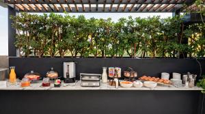 a table with food on a counter with trees at The Amsterdam by Viadora in Mexico City