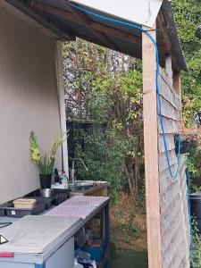 a backyard kitchen with a table and a sink at The Old Waterworks - Saturn 6m bell tent in Clare