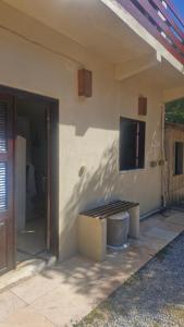 a building with a door and a tv on the wall at Suíte privada in Jericoacoara