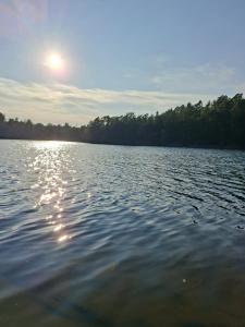 a large body of water with the sun reflecting on it at Värmdö Ängsv. in Djurhamn