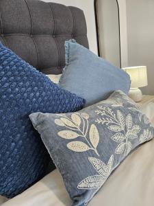 a pile of pillows sitting on top of a bed at Rosa's Self-catering Unit 2 in Springbok
