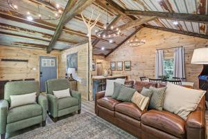 a living room with leather furniture and wooden walls at Rustic Retreat — Easy Access, Peaceful Setting, Close to Everything in Sevierville