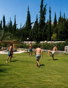 a group of men playing a game of frisbee at RIAD YANITRI Piscine chauffée in Essaouira