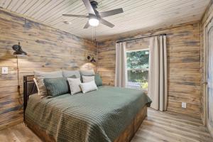 a bedroom with a bed and a ceiling fan at Rustic Retreat — Easy Access, Peaceful Setting, Close to Everything in Sevierville