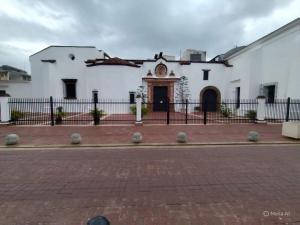 a white building with a fence in front of it at Twin Bed Room-King Room Zona Colonial in Santo Domingo