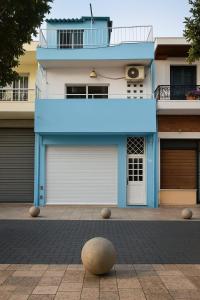 a white and blue building with two garage doors at Twin Bed Room-King Room Zona Colonial in Santo Domingo +2 photos