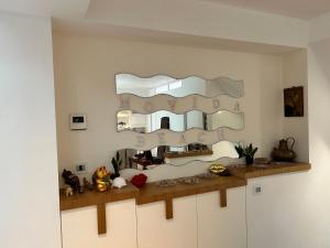 a mirror on top of cabinets in a room at movida beach in Bari