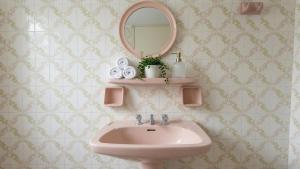 a bathroom with a sink and a mirror at Kineta Prime Suites No3 in Kineta