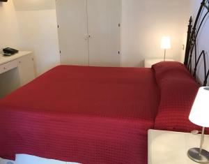 a red bed in a small room with two lamps at Relais Masseria della Colomba - Agriturismo in Francavilla Fontana +40 photos