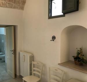 a room with two chairs and a table and a window at Relais Masseria della Colomba - Agriturismo in Francavilla Fontana