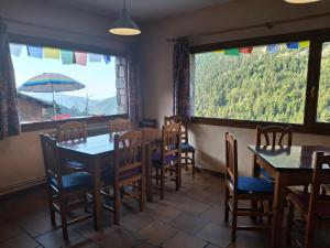 a dining room with tables and chairs and a large window at Setcases-Vallter Hostal Mitja Pensió 5 in Setcases +14 photos