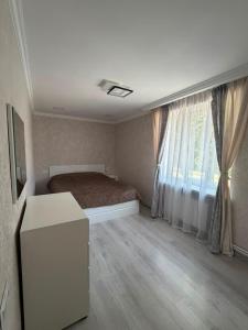 a bedroom with a bed and a window at Njoy in Jermuk