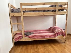 a wooden bunk bed with a mattress on a wooden floor at movida beach in Bari