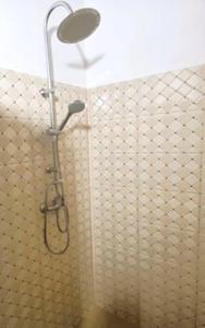 a shower with a shower head in a bathroom at Timonier Ecolodge in Mar Lodj