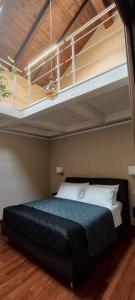 a bedroom with a large black bed in a room at B&B Sa Costera in Iglesias