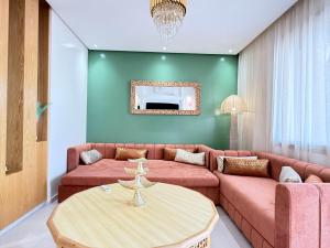 a living room with a couch and a table at Riad Marrakech, oasis apartment in Marrakesh