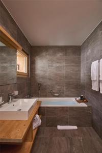 a bathroom with a tub and a sink at Dent Blanche Resort - TemptingPlaces Collection in Hérémence +48 photos