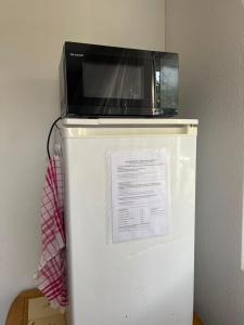 a microwave sitting on top of a refrigerator at Tengs in Triboltingen
