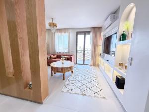 a living room with a couch and a table at Riad Marrakech, oasis apartment in Marrakesh