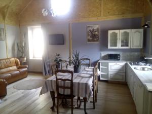 a kitchen and dining room with a table and chairs at Le relais de la mine in Champagnac