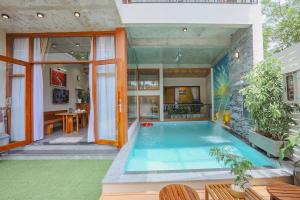 a swimming pool in the middle of a house at DQ Peaceful Villa in Thôn Dương Xuân Hạ