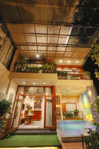 a house with a swimming pool and a balcony at DQ Peaceful Villa in Thôn Dương Xuân Hạ