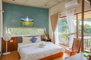 a bedroom with a bed with a teddy bear on it at DQ Peaceful Villa in Thôn Dương Xuân Hạ