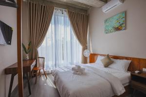 a bedroom with a bed with a teddy bear on it at DQ Peaceful Villa in Thôn Dương Xuân Hạ +6 photos
