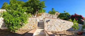 a set of stairs leading up to a stone wall at B&B Sa Costera in Iglesias