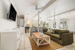 a living room with a couch and a table at The Palms in Redcliffe