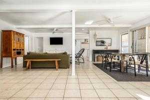 a living room with a couch and a table at The Palms in Redcliffe