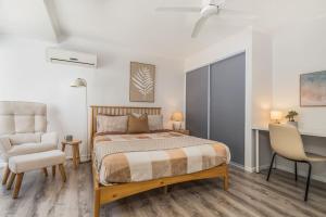 a bedroom with a bed and a chair and a desk at Margate Beach Studio 4 in Redcliffe